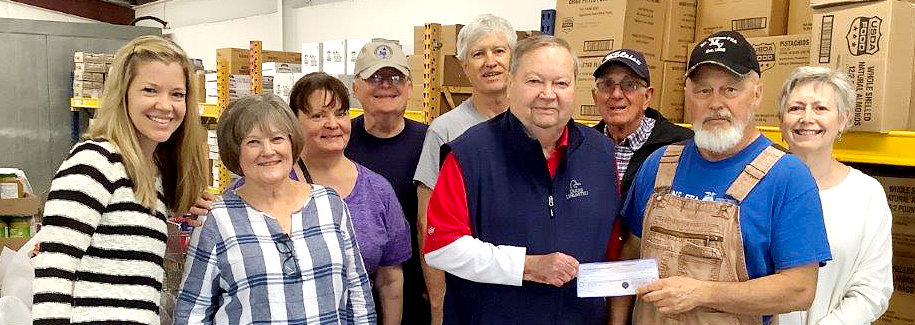Wood County Electric Charitable Foundation board member David Maxton presents a check to the Community Food Bank of Franklin County.
